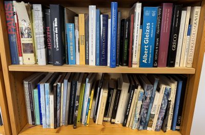 a book shelf with many books on it in a room