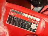someone is holding a red electric drill in their hand
