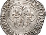 a silver coin with fleures on the reverse of it
