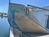 a boat that is sitting in the water near a dock