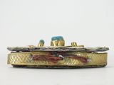 an image of a gold box with a turquoise stone on top of it