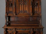 an old wooden cabinet with ornate carvings on the top