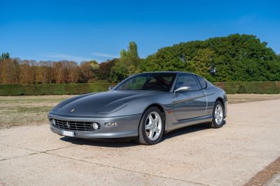 a silver sports car parked on the side of the road