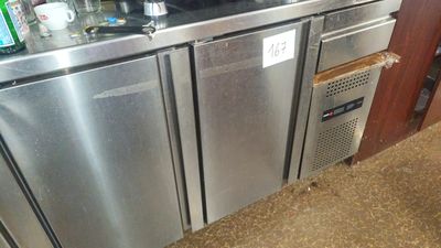 a stainless steel refrigerator with a lot of bottles on top of it