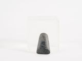 a black rock in a clear glass container