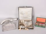 a silver case with silverware in it on a table