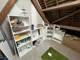 a room that has a shelf with boxes and boxes on it