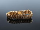 a close up of a gold ring on a black surface
