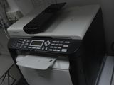 a printer that is sitting on top of a stack of papers