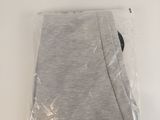 a close up of a pair of grey pants on a white surface