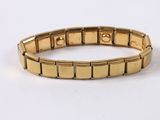 a close up of a gold bracelet on a white surface