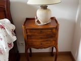 a lamp that is on top of a table in a bedroom