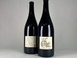two bottles of wine sitting next to each other on a table