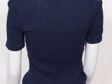 the back view of a mannequin wearing a blue sweater