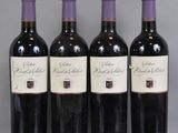 three bottles of wine are lined up on a table