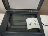 a printer with a note on it sitting on top of a table