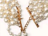 pearl necklace with a gold cross and a cross on a chain