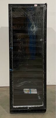 a broken glass door with a sticker on it