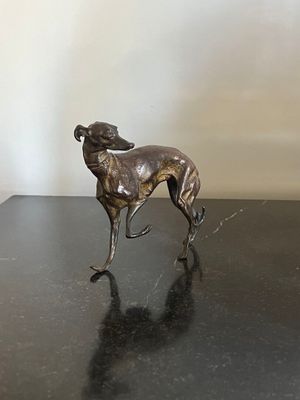 bronze statue of a dog on a black table