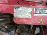a red motorbike that is sitting in the garage