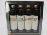 three bottles of wine in a box on a white surface