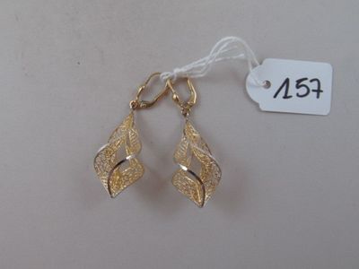 pair of gold tone earrings on a white background with a price tag