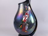 a black vase with a picture of a clown on it