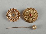 two gold tone brooches with pearls and a red bead