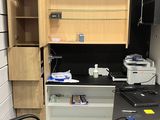 a desk with a computer and a chair in a room