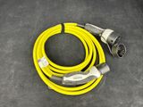 a close up of a yellow extension cable connected to an electrical outlet