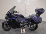 a blue motorcycle that is parked on a checkered floor