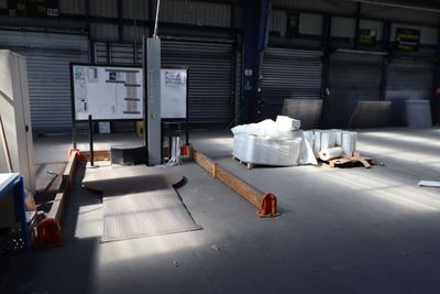a large warehouse with a lot of items on the floor