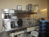 a kitchen with a lot of dishes and cups on the counter