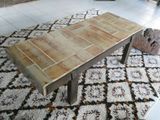 a coffee table that is sitting on a rug in a living room