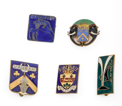four lapel pins of different shapes and colors on a white surface