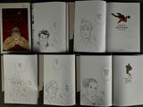 six books with drawings of people on them on a table
