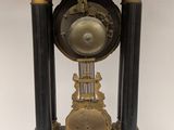 a black and gold clock sitting on top of a table