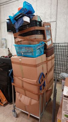 many boxes stacked on top of each other on a cart