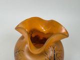 a brown vase with a tree design on it