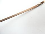 a metal spoon with a handle on a white surface