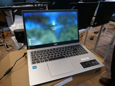a laptop computer sitting on top of a box on a table