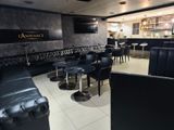 a room with black leather chairs and tables in it