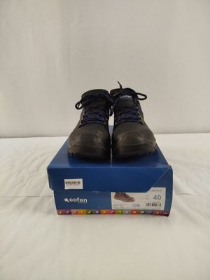 men ' s shoes in a box on a bed with a white background