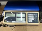 a scale with a calculator sitting on top of it