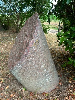 a large rock sitting in the middle of a field