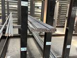 many steel bars stacked on top of each other in a warehouse