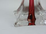 a glass vase with a red candle inside of it