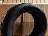 tire on the floor next to a cardboard box in a warehouse