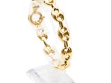 a close up of a gold ring on a clear stand