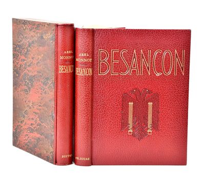 two red books sitting next to each other on a white surface